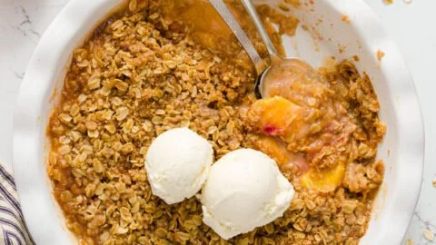 Delicious homemade peach crisp dessert with crunchy topping and juicy peaches