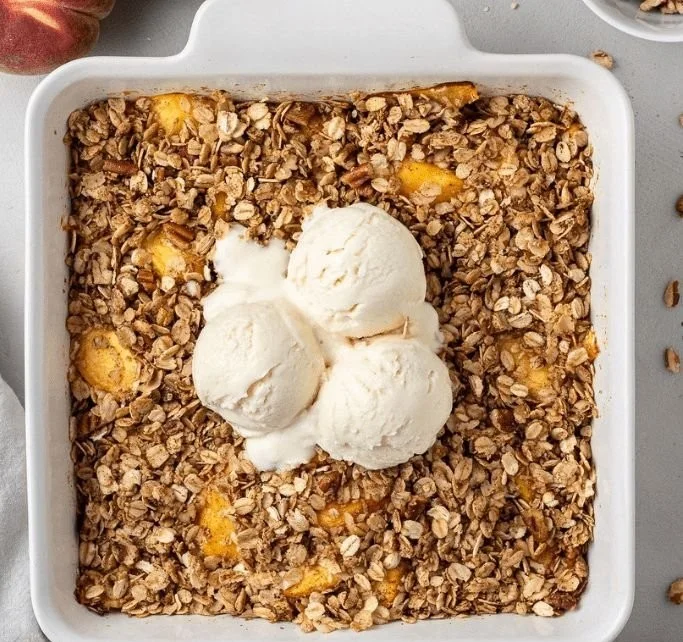 Delicious homemade Peach Crisp topped with crunchy oat and brown sugar topping