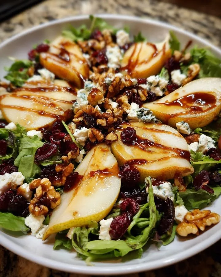 Delicious pear goat cheese salad with candied walnuts and cranberry vinaigrette