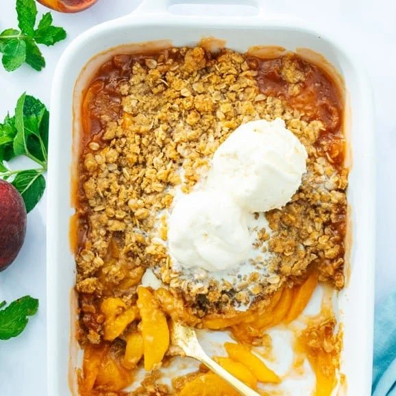 Delicious peach crisp dessert with fresh peaches and crispy topping