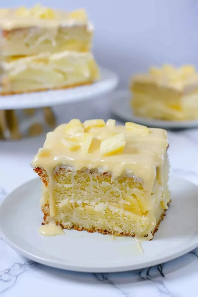 Delicious slice of Perfect Pineapple Cake on a plate with fresh pineapple slices