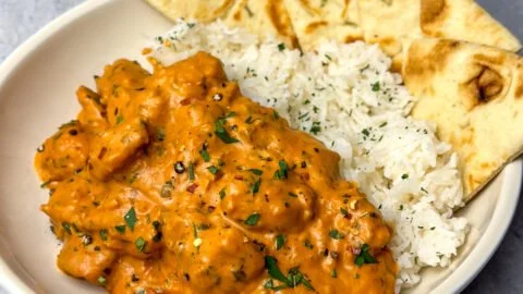Delicious homemade butter chicken served with rice and naan bread
