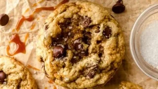 Plate of salted caramel chocolate chip cookies with a sprinkle of sea salt
