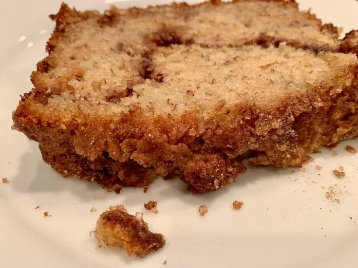 Loaf of freshly baked snickerdoodle banana bread with cinnamon sugar topping.
