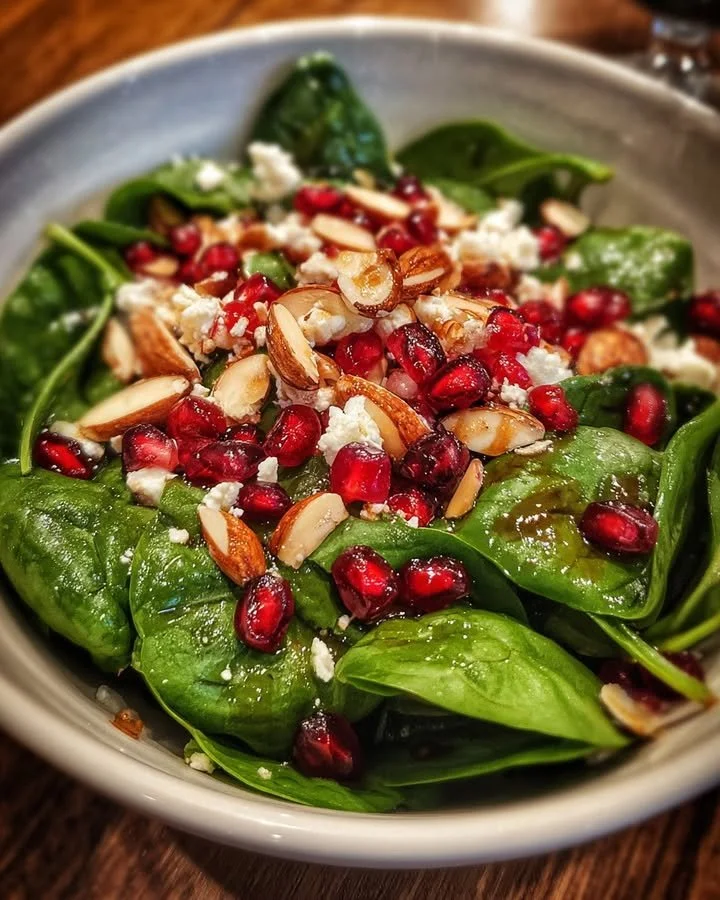 Delicious Spinach Salad with pomegranate, feta cheese, and toasted almonds.