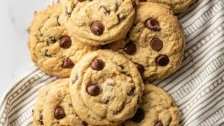Freshly baked stay soft chocolate chip cookies on a cooling rack.