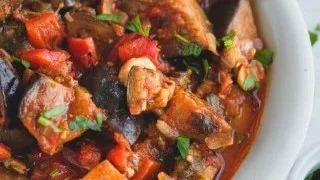 Delicious stewed eggplant in tomato sauce served in a bowl