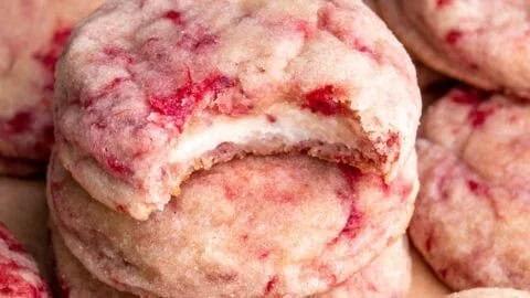 Freshly baked strawberry cheesecake cookies with a creamy topping