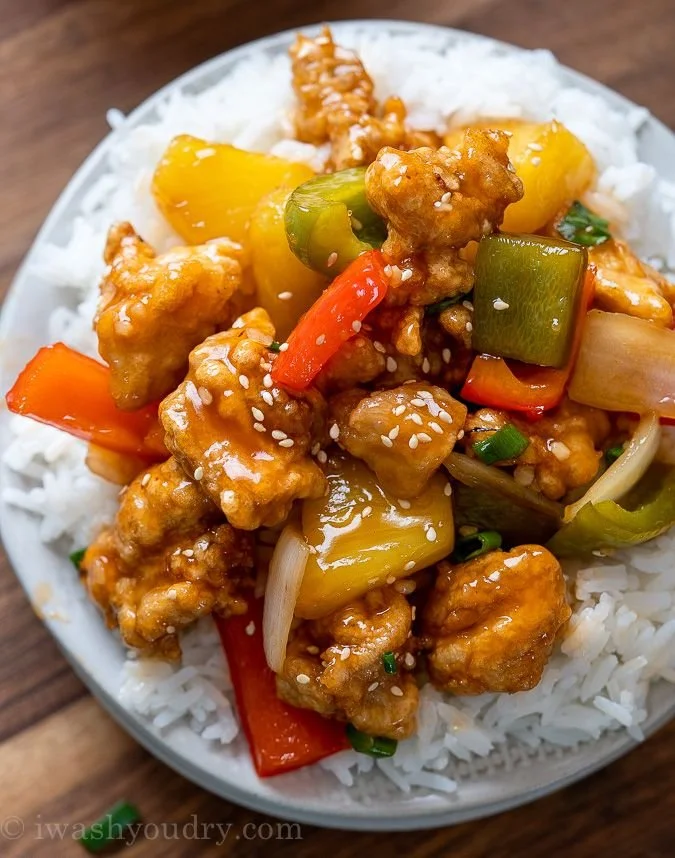 Delicious plate of Sweet and Sour Chicken with colorful vegetables.