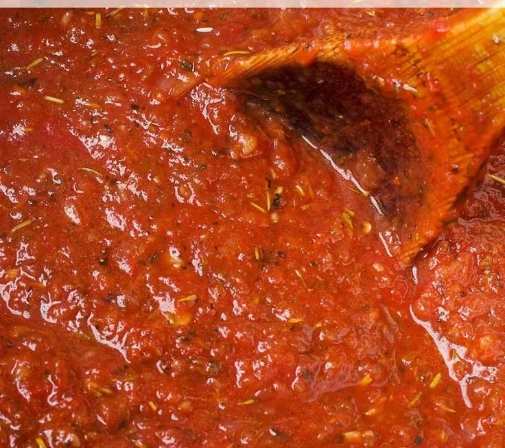 A bowl of delicious homemade marinara sauce with fresh herbs and spices