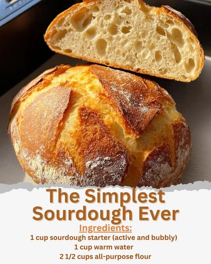 A loaf of freshly baked sourdough bread on a wooden cutting board