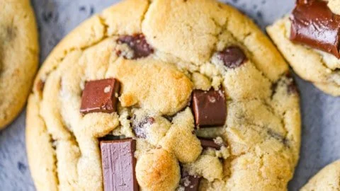 Thick and chewy chocolate chip cookies on a baking tray