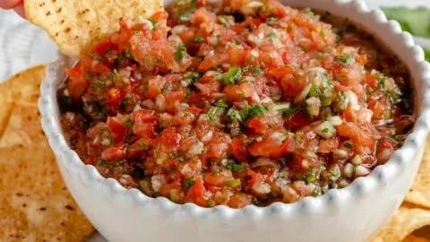 A bowl of Tony's Ridiculously Easy Homemade Salsa with fresh ingredients