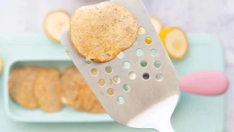 Fluffy baby banana pancakes topped with fresh fruit and syrup