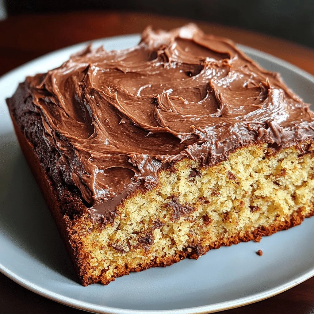 Delicious banana cake topped with creamy chocolate frosting on a white plate