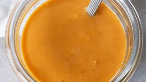 Bowl of creamy Bang Bang Sauce with shrimp and vegetables