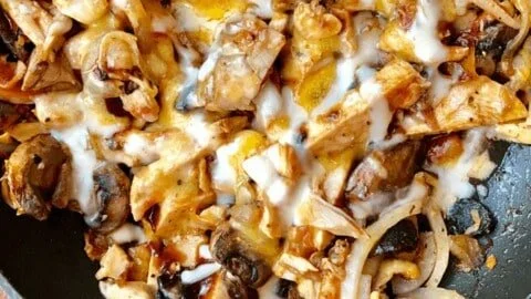 Delicious BBQ chicken thighs cooked on a grill, showcasing perfect caramelization.