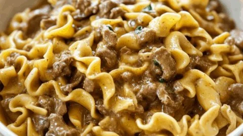 Delicious bowl of beef noodles topped with fresh herbs and spices