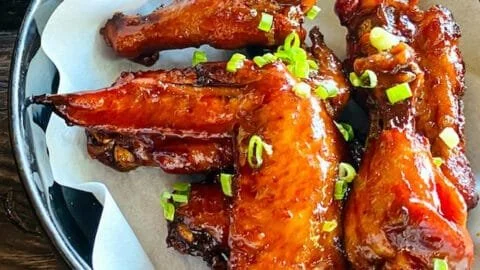 Delicious bowl of best chicken wing sauce with fresh wings