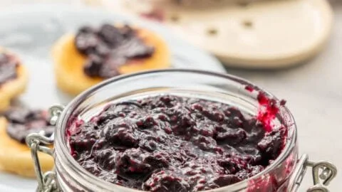 Homemade blueberry chia jam in a jar on a wooden table
