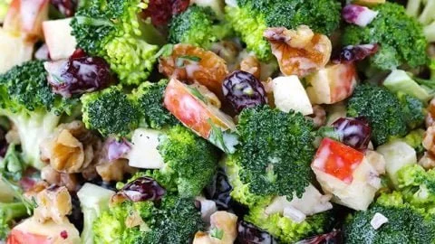 Broccoli salad with apples, walnuts, and cranberries in a bowl