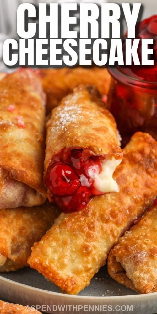 Delicious cherry cheesecake egg rolls served with a cherry topping.