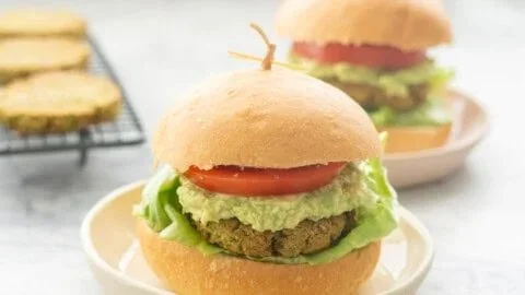 Homemade chickpea patties served on a plate with fresh vegetables