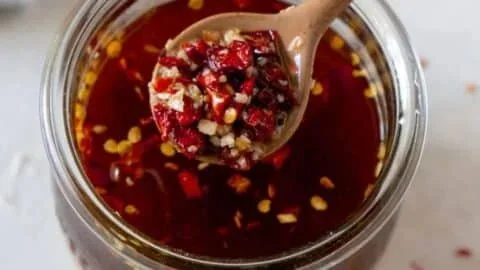 Chili Garlic Sauce in a jar with chopped garlic and chili peppers