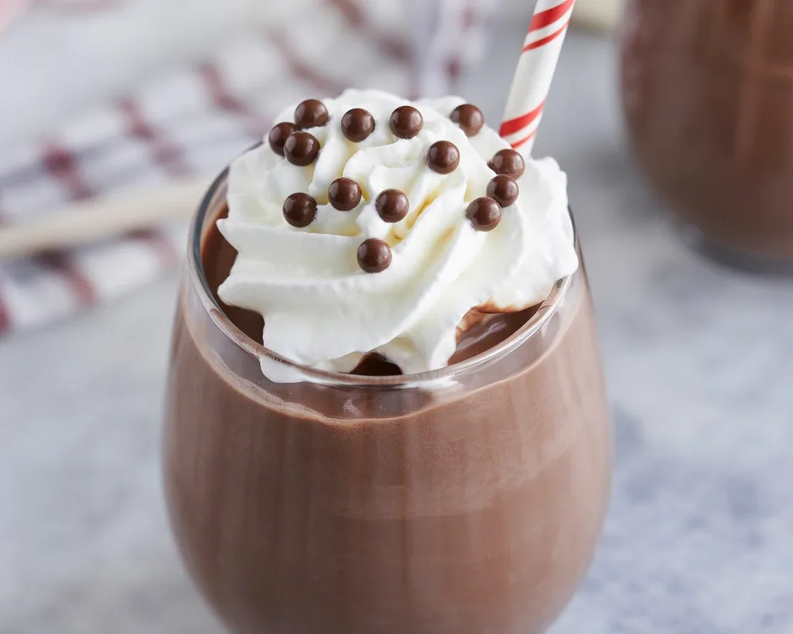 Refreshing and indulgent Frozen Hot Chocolate topped with whipped cream and chocolate curls.