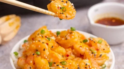 Plate of Copycat P.F. Chang's Dynamite Shrimp garnished with green onions