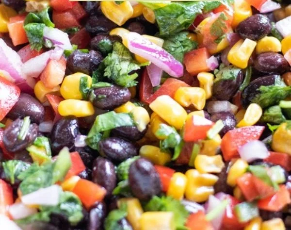 Colorful Corn and Black Bean Salad with fresh vegetables and dressing