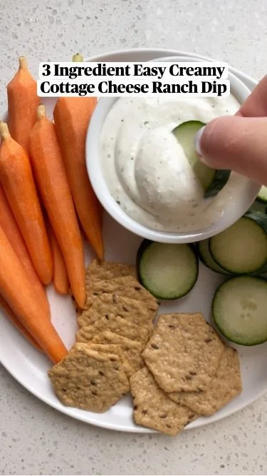 A bowl of Cottage Cheese Ranch Dip served with fresh veggies and crackers.