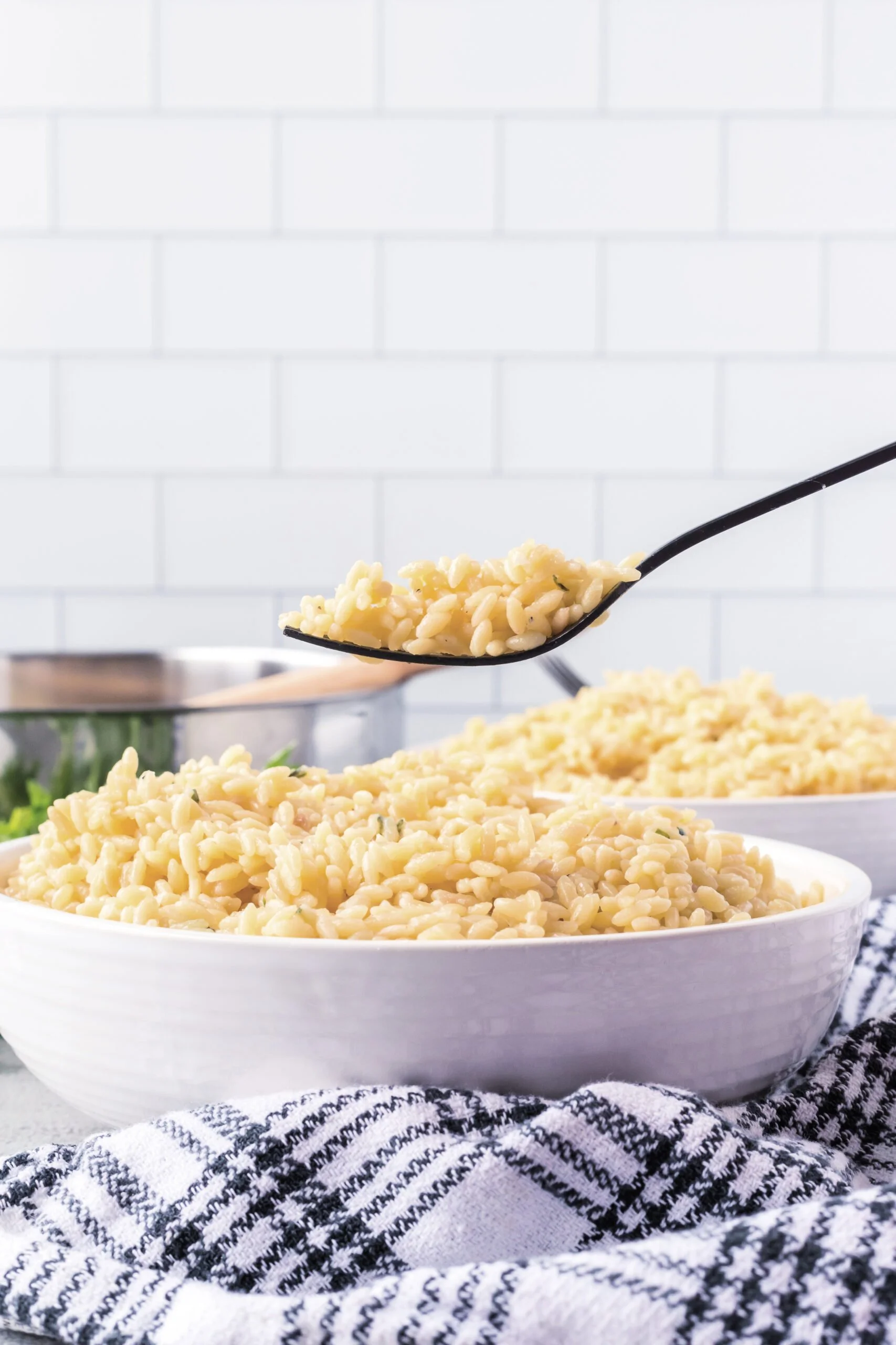 Creamy Garlic Parmesan Orzo served in a white bowl with herbs