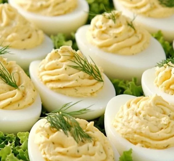 Delicious deviled eggs topped with cream cheese for a creamy twist.