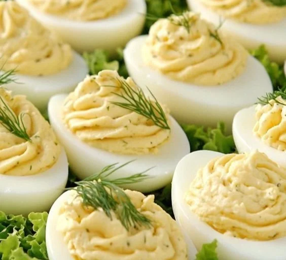 Delicious deviled eggs with cream cheese on a serving platter.