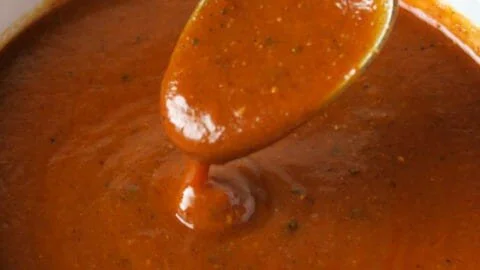 Homemade red enchilada sauce in a bowl ready for use in recipes.