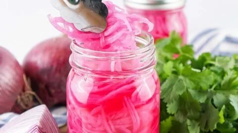Jar of easy refrigerator pickled red onions for quick and tangy flavor.
