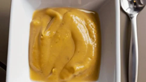 Effortless honey mustard sauce recipe ingredients and prepared sauce in a bowl