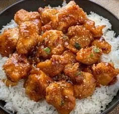 Delicious plate of General Tso's Chicken with vegetables and rice