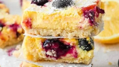 Healthy keto blueberry lemon bars topped with fresh blueberries and lemon zest