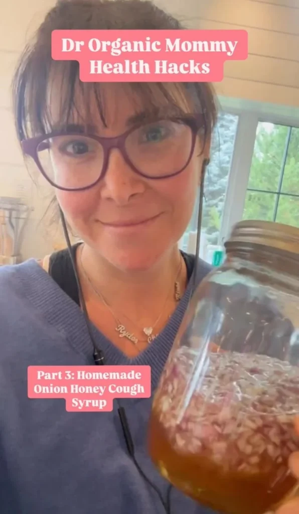 Homemade onion honey cough syrup in a glass jar with onions and honey