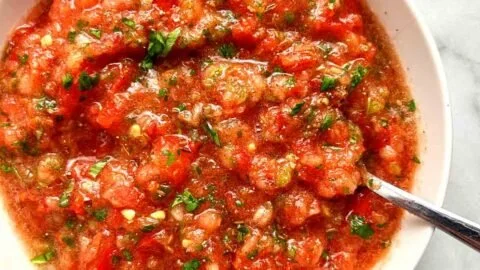 Bowl of fresh homemade salsa with ingredients like tomatoes, onions, and cilantro