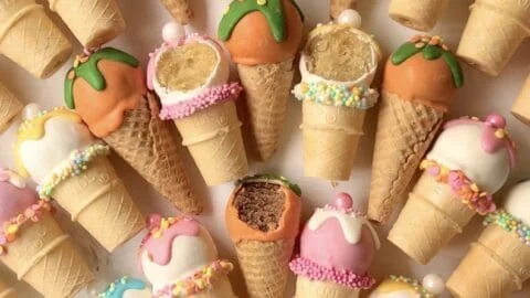 Colorful ice cream cake pops on a decorative plate, perfect for parties.