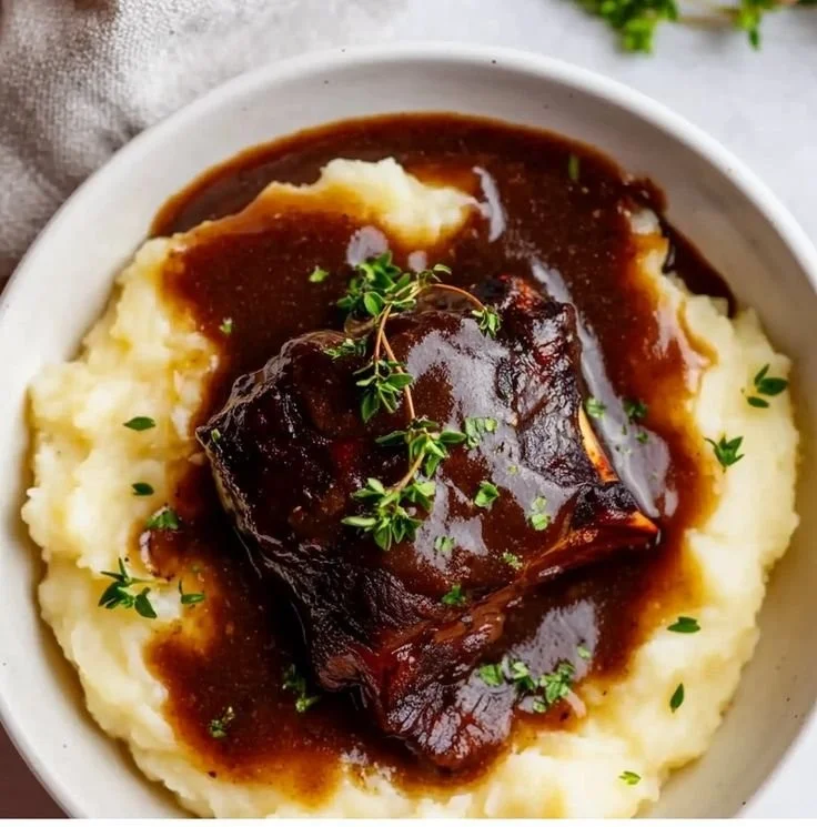 Juicy beef short ribs cooked in a Dutch oven with aromatic spices and herbs