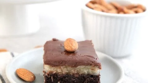 Delicious Keto Almond Joy Brownies topped with chocolate and coconut layers
