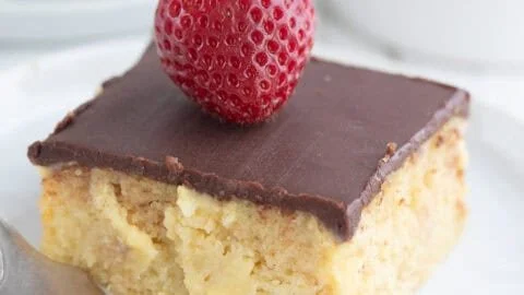 Delicious Keto Boston Cream Poke Cake topped with chocolate and cream