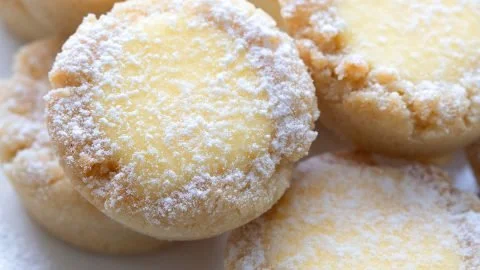 Keto Lemon Bar Cookies with a zesty lemon glaze on a white plate