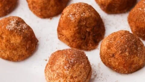 Keto no-bake pumpkin pie cheesecake bites on a white plate