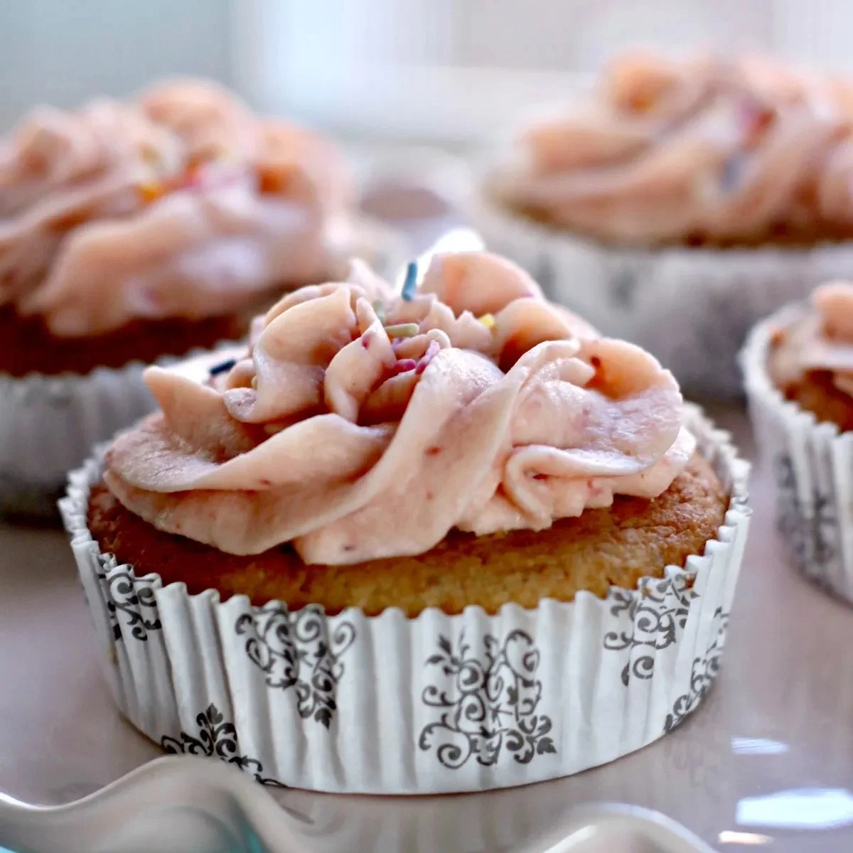 Delicious Keto Strawberry Cake topped with fresh strawberries and whipped cream