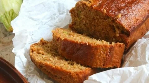 Freshly baked Keto Zucchini Bread sliced on a wooden board
